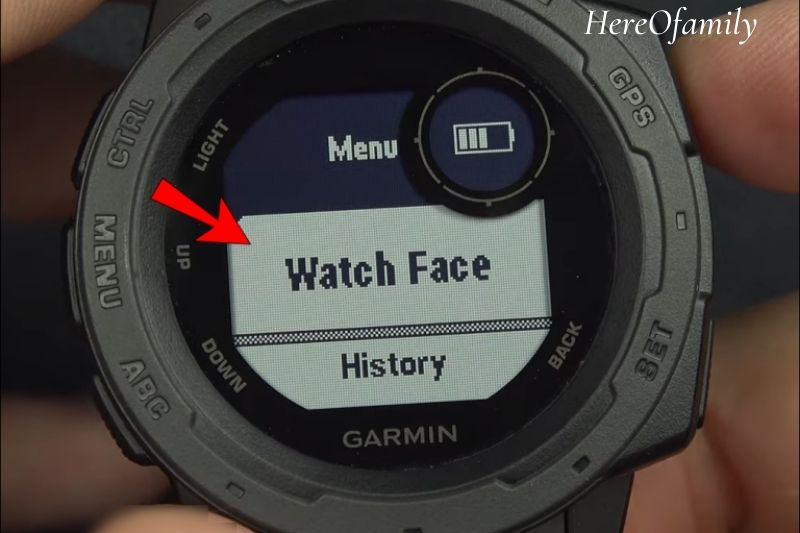 Press and hold the “Up” button on your watch and select “Watch Face.”
